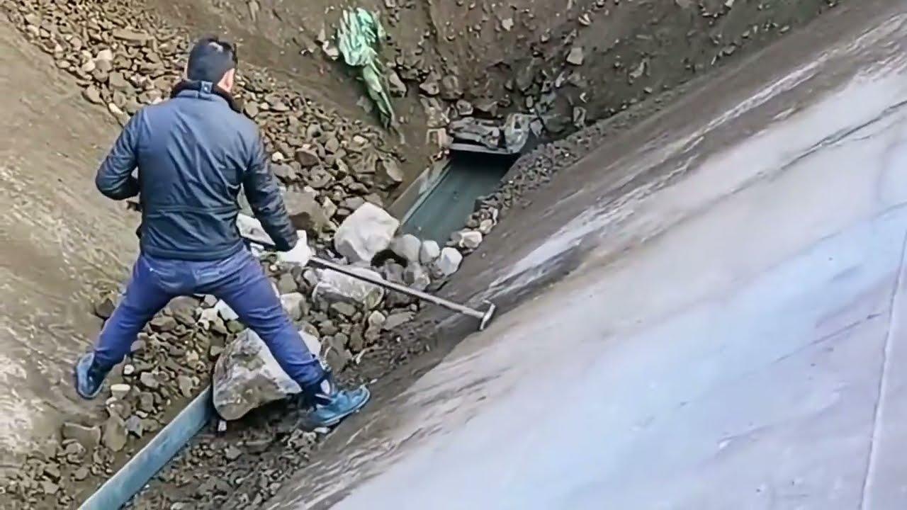 Barge unloading soil with large stones, daily work on the river