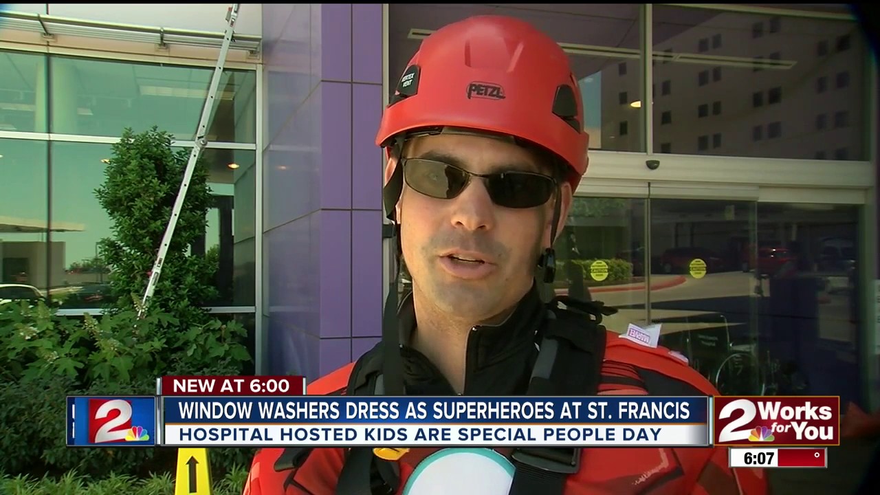 Window washers dressed as superheroes work at Saint Francis Children's Hospital