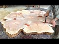 Woodworking masterpiece with strange tree stump  a sturdy wooden table for the garden to look new