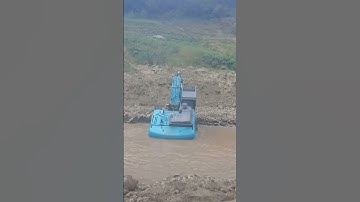 Excavator coming out of water