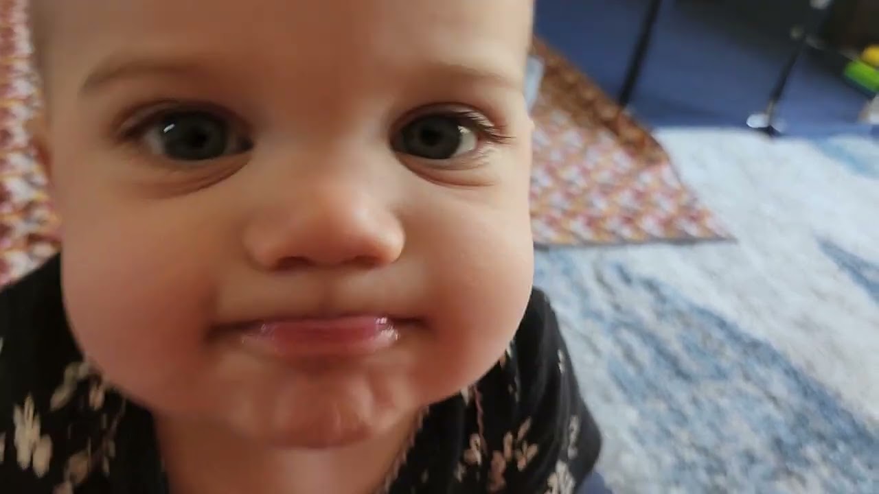 twins play trying to pick a toy