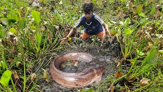 Primitive Fishing Culture.   Traditional Boy Catching r Catfish By Hand In River Side.