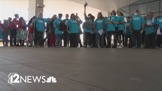 Airport workers hold rally near Sky Train demanding better pay, benefits