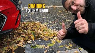 #079-2 Unclogging a storm drain on a parking space during rain in Germany