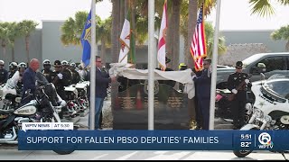 Police union presents checks to families of fallen PBSO deputies