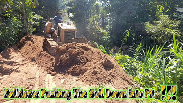 Bulldozer pushing the soil into pit and pushing stone ! complete ! dumptruck mitsubishi bd2f working