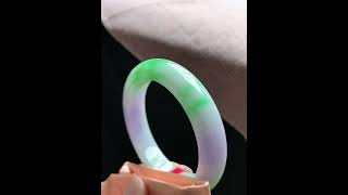 Natural Jade, A Translucent Spring-Colored Bangle With A Clear Circular Pattern And Wide Edges.