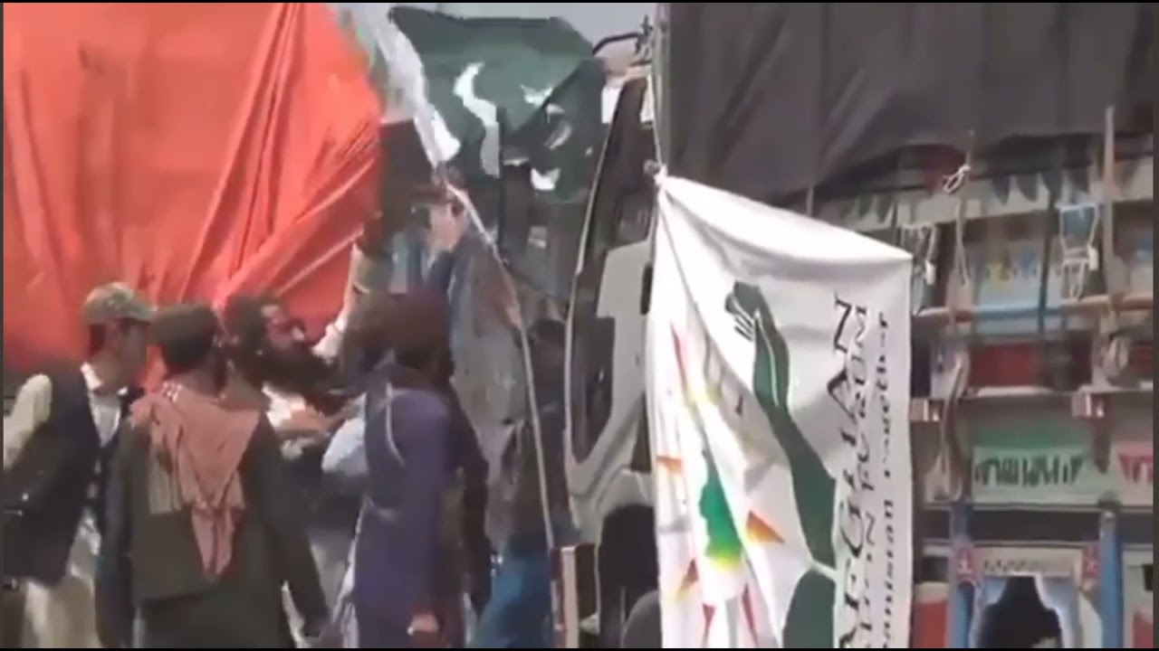 Taliban soldiers remove Pakistan flag from truck