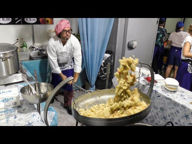 Huge Pan with Italian Pasta Paccheri, Pepper and Codfish. Italian Street Food