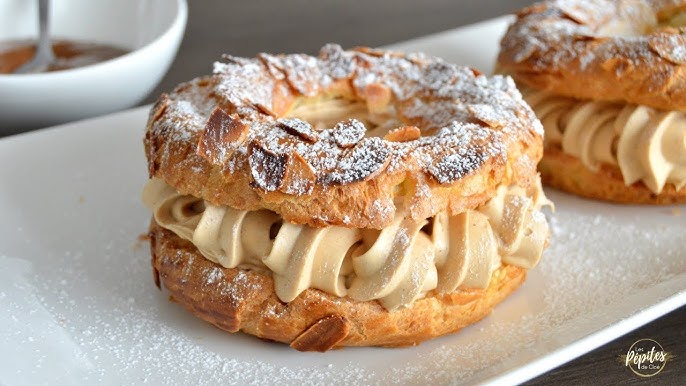 Tripadvisor - Le Paris Brest, une pâtisserie française gourmande composée  d'une pâte à choux agrémentée d'amandes effilées grillées et généreusement  garnie d'une crème légère au pralin. Inventée pour honorer la course  cycliste