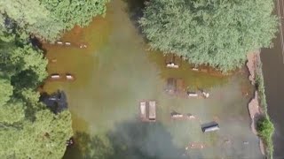 Coffins float at Orangefield cemetery during Imelda's flooding