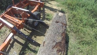 Woodmizer sawmill video: Loading a big Cherry log using the winch. I purchased the log deck package that helps in processing the 