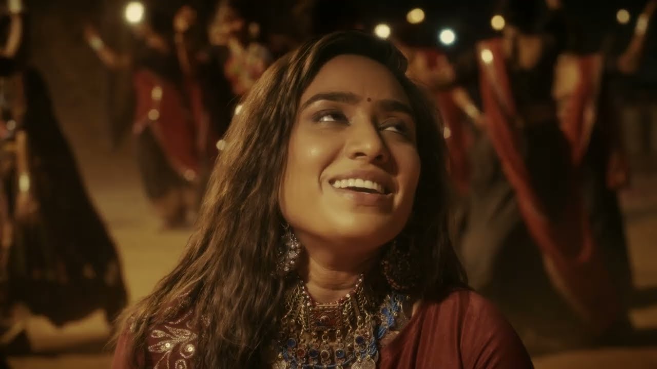 Ishani Dave smiling among garba dancers, from Bheliyo