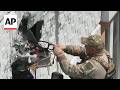 Technicians remove an unexploded drone from a building in Ukraine