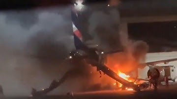 Plane full of passengers catches fire