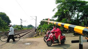 Gateman Trying To Close Railgate public Randomly Crossing High speed Train Furiously Coming On Yard