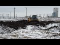 The bulldozer fighting with mud in quarry