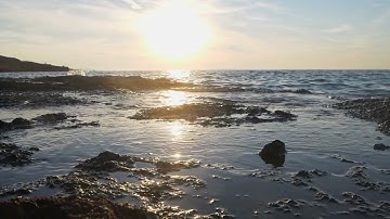 Rough coastline and golden sunlight, wide tracking shot | Free stock footage
