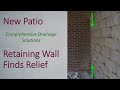 Drainage system stabilizes retaining wall