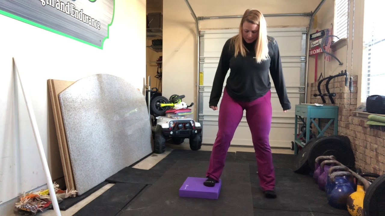 Uneven squats with balance pad to help build lower extremity strength