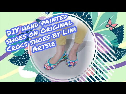 crocs with feet painted on them