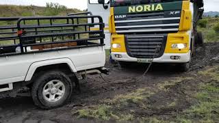 Toyota Landcruiser tows stuck in the mud 34 ton truck and trailer uphill