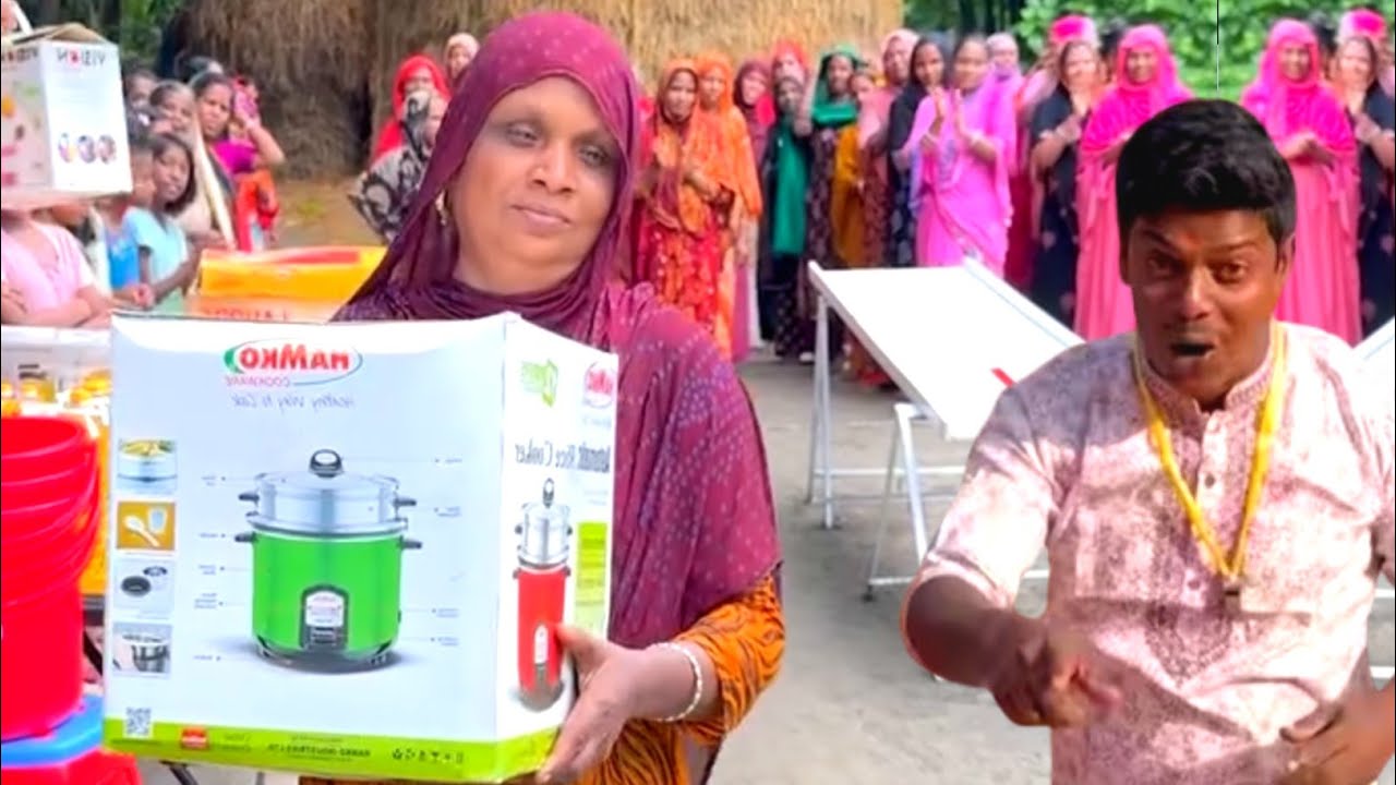 Challenge to win the prize by rolling the giant ball into hole The women of the village won gifts