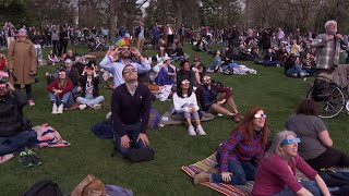 Crowds watch eclipse in Central Park despite a few clouds