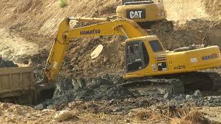 Excavator working use hand clear Swamp Land stone loading construction company land truck