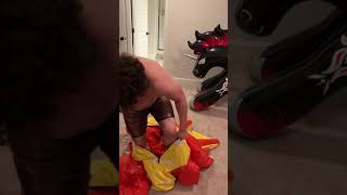 Getting dressed in a red pvc inflatable dragon suit