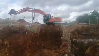 Doosan 225LCA digging a drain