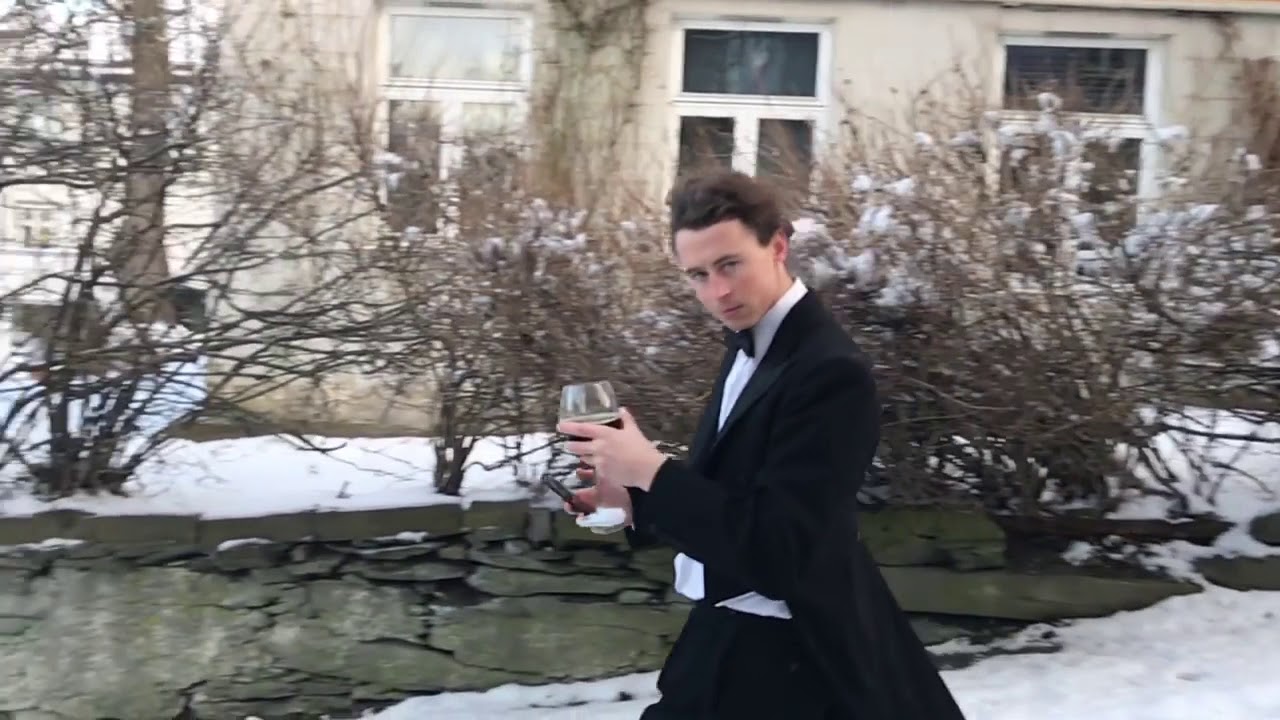 Guy Slides Down Icy Street With Glass of Wine in One Hand and Mobile Phone in Other - 1107031