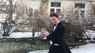 Guy Slides Down Icy Street With Glass of Wine in One Hand and Mobile Phone in Other - 1107031
