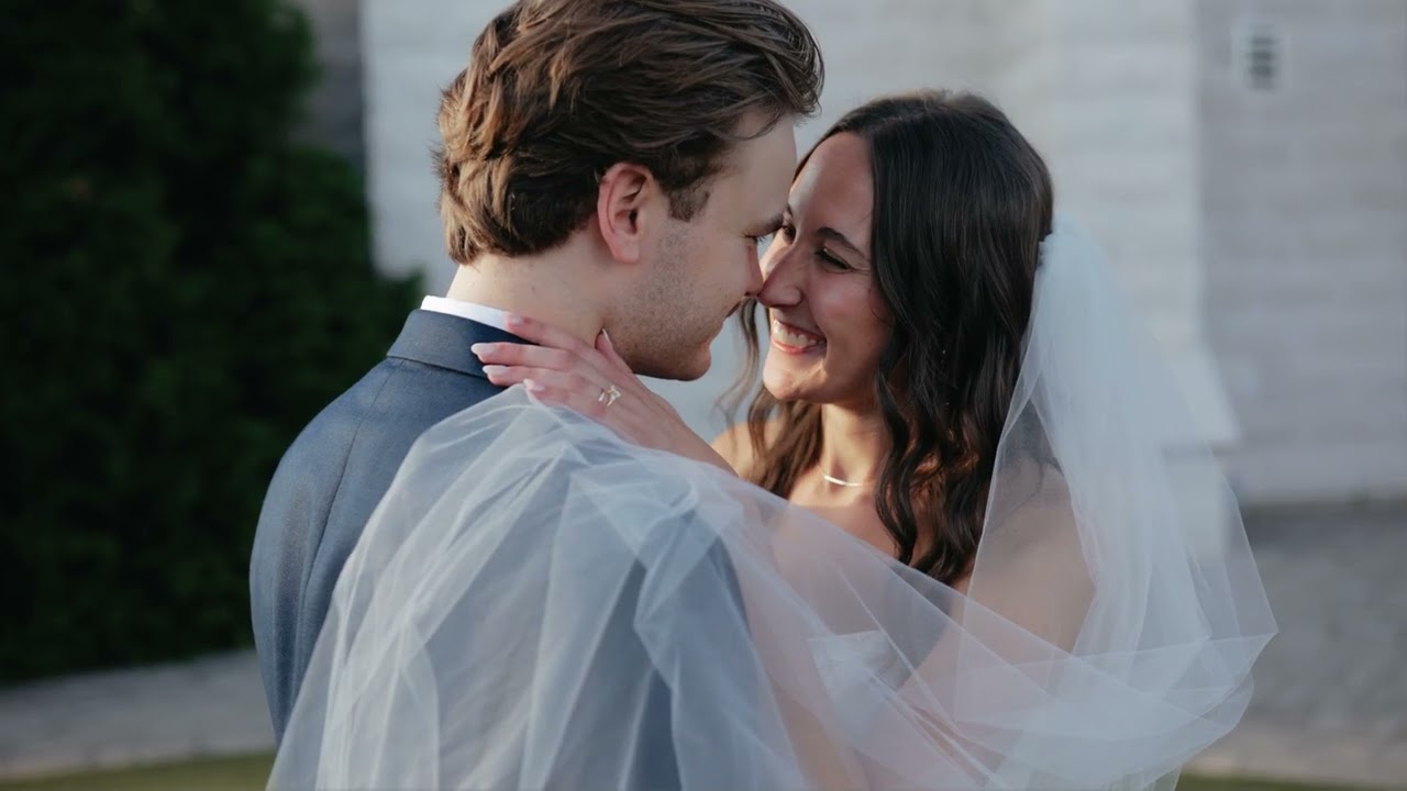 Bride and groom about to kiss, her veil wrapped around them, at Chapel on McEver in Gainesville, GA