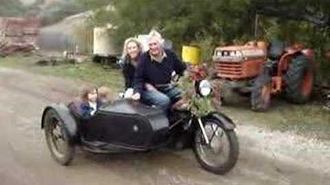 A 1957 Nimbus Motorcycle with Sidecar and Kids