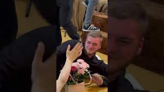 Man Slips While Holding Flowers and Gift, Plays It Off Smoothly
