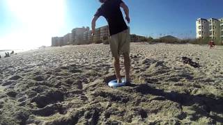 Beach flipping with an exercise ball.