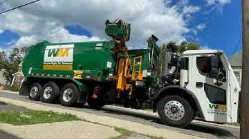 Brand new WM Labrie dumping heavy trash barrels