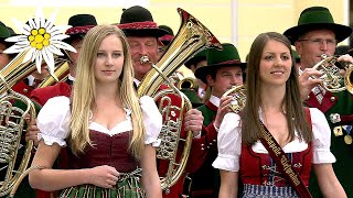 Big band plays marching music in front of a beautiful basilica in Austria