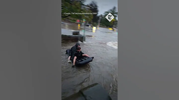 Boys use air mattress as river raft in Storm Babet floodwaters