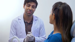 Stock video of cute Indian girl talking with the doctor and smiling