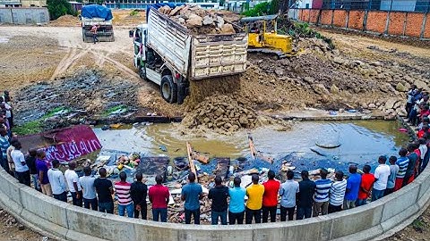 Incredible work Completely 100%!! Dump Truck unloading soil to fill flooded land with Dozer pushed
