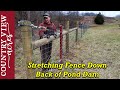 Stretching Fence Down the back side of the Pond Dam