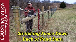 Stretching Fence Down the back side of the Pond Dam