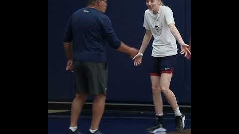 Paige Bueckers playfully arguing with Geno Auriemma