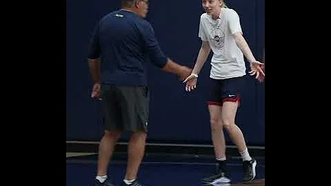 Paige Bueckers playfully arguing with Geno Auriemma