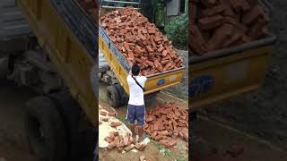 Tipper dumping pile of bricks