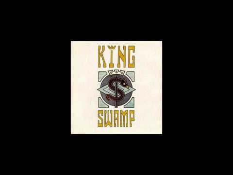 King Swamp Man behind a gun