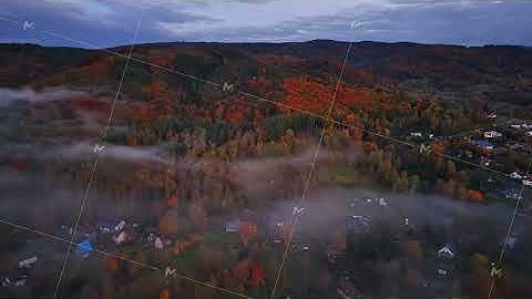 early fog surrounds quiet village, serene village immersed in autumn fog with rooftops visible