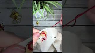 Decorating a button with a toadstool embroidery